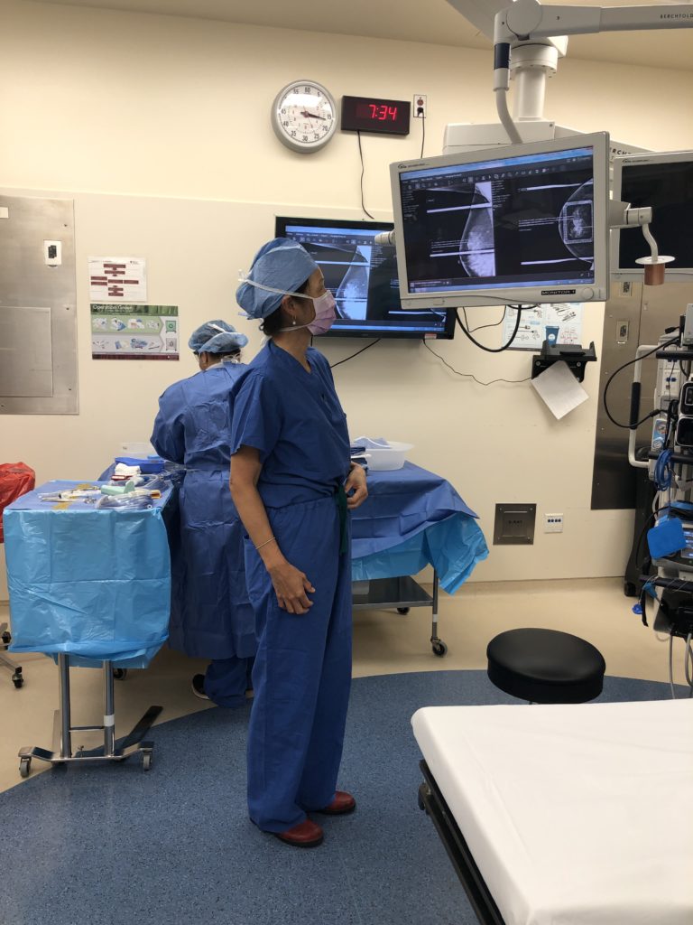 This is a photo of Dr. Jocelyn Dunn M.D. examining images in the operating room