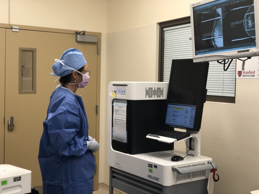 This is a photo of Dr. Jocelyn Dunn M.D. examining images in the operating room